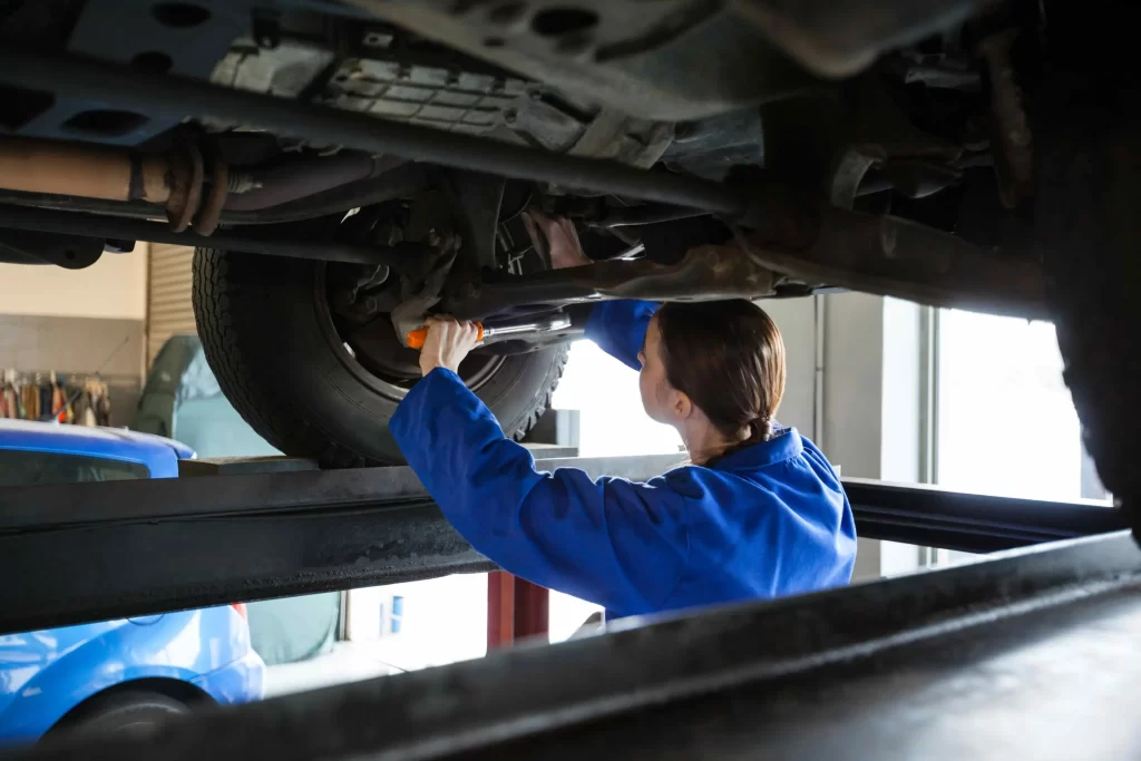 A fleet maintenance staff member changing oil in a truck to ensure it will work properly.