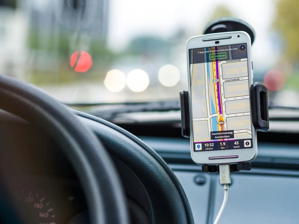 Car dashboard with smartphone GPS navigation app mounted for real-time directions