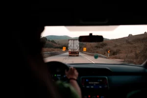 Driver following a truck on a highway, symbolizing road awareness and safe driving practices for commercial fleets.