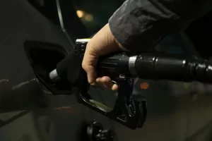 Hand refueling a vehicle at a gas station