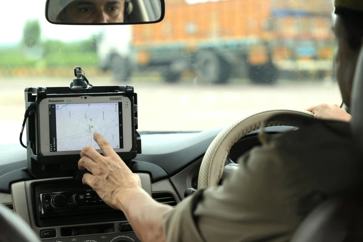Driver using an in-car tablet GPS tracking device for route management