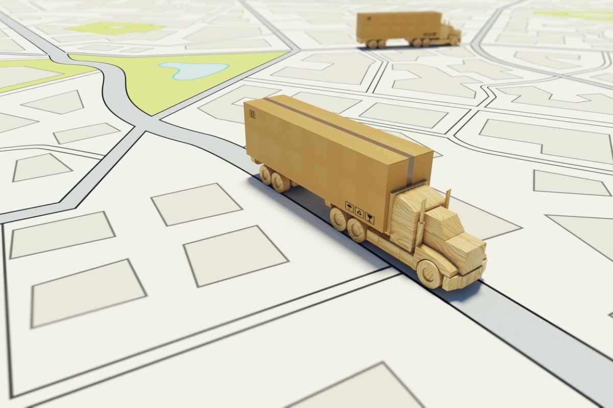 Delivery of a large box on a road map with a lorry